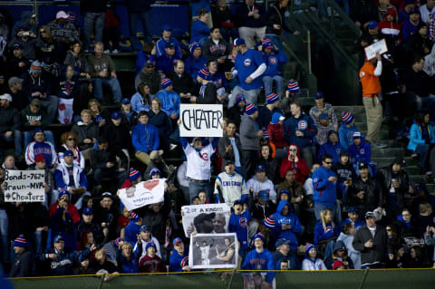 CHICAGO, IL – APRIL 9: Chicago Cubs fans hold up signs to taunt left fielder Ryan Braun #8 of the Milwaukee Brewers at Wrigley Field on April 9, 2012 in Chicago, Illinois. (Photo by Brian Kersey/Getty Images)