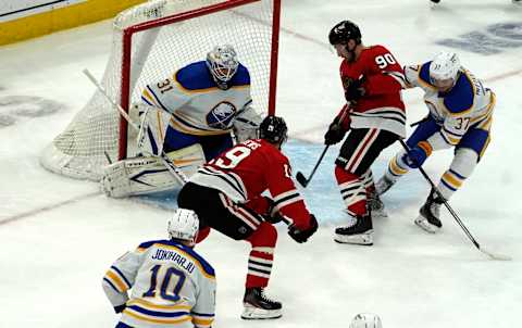 Mar 28, 2022; Chicago, Illinois, USA; Chicago Blackhawks center Jonathan Toews (19) scores a goal on Buffalo Sabres goaltender Dustin Tokarski (31) during the first period at United Center. Mandatory Credit: David Banks-USA TODAY Sports