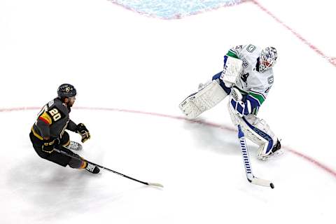 Jacob Markstrom #25 of the Vancouver Canucks clears the puck away from Chandler Stephenson #20 of the Vegas Golden Knights during the first period in Game Two of the Western Conference Second Round. (Photo by Bruce Bennett/Getty Images)