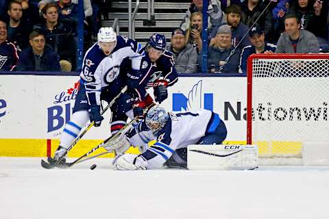 COLUMBUS, OH – APRIL 6: Eric Comrie #1 of the Winnipeg Jets makes a save as Nelson Nogier #62 of the Winnipeg Jets works to keep Josh Anderson #34 of the Columbus Blue Jackets way from the rebound during the game on April 6, 2017 at Nationwide Arena in Columbus, Ohio. Winnipeg defeated Columbus 5-4. (Photo by Kirk Irwin/Getty Images)