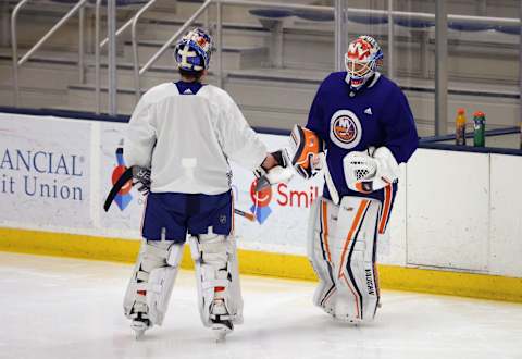 Cory Schneider #35 (R) greets Ilya Sorokin #30 of the New York Islanders (L). (Photo by Bruce Bennett/Getty Images)