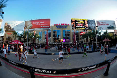 Oct 9, 2014; Glendale, AZ, USA; Young fans play street hockey prior to the game between the Arizona Coyotes and the Winnipeg Jets at Gila River Arena. Mandatory Credit: Matt Kartozian-USA TODAY Sports