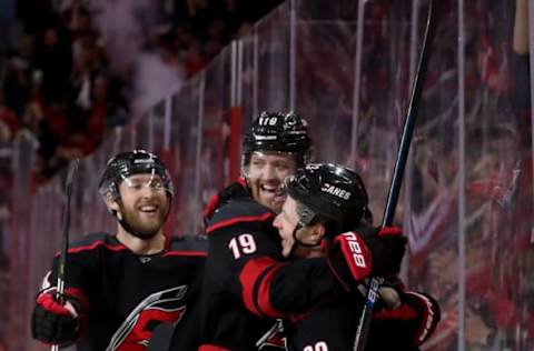 RALEIGH, NC – APRIL 15: Brock McGinn #23 of the Carolina Hurricanes scores a goal an celebrates with teammates Dougie Hamiton #19 and Jaccob Slavin #74 in Game Three of the Eastern Conference First Round against the Washington Capitals during the 2019 NHL Stanley Cup Playoffs on April 15, 2019 at PNC Arena in Raleigh, North Carolina. (Photo by Gregg Forwerck/NHLI via Getty Images)