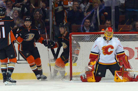 Mar 30, 2016; Anaheim, CA, USA; Calgary Flames goalie Jonas Hiller (1) reacts in goal as center Brandon Pirri (11), Anaheim Ducks center Shawn Horcoff (22) and defenseman Cam Fowler (4) celebrate a goal in the first period of the game at Honda Center. Mandatory Credit: Jayne Kamin-Oncea-USA TODAY Sports