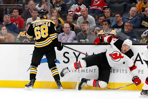 BOSTON, MA – SEPTEMBER 25: Boston Bruins center Jack Studnicka (68) knocks down New Jersey Devils defenseman Matt Tennyson (7) during a preseason game between the Boston Bruins and the New Jersey Devils on September 25, 2019, at TD Garden in Boston, Massachusetts. (Photo by Fred Kfoury III/Icon Sportswire via Getty Images)