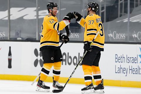 Mar 27, 2021; Boston, Massachusetts, USA; Boston Bruins right wing Craig Smith (12) is congratulated by center Patrice Bergeron (37) after their 3-2 win over the Buffalo Sabres at TD Garden. Mandatory Credit: Winslow Townson-USA TODAY Sports