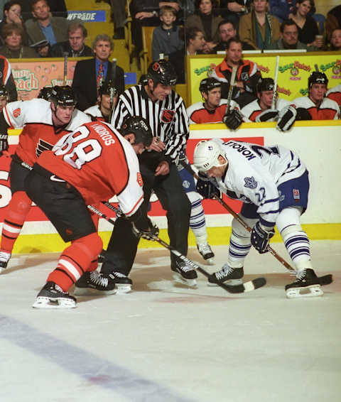 Linseman Derek Amell drops the puck between Eric Lindros #88  . (Photo by Graig Abel/Getty Images)