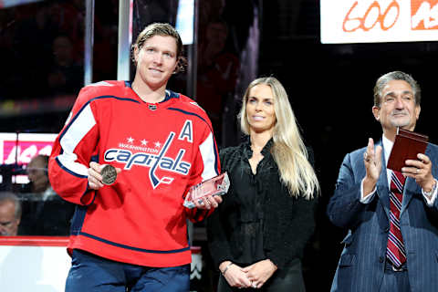 WASHINGTON, DC – NOVEMBER 07: Nicklas Backstrom #19 of the Washington Capitals poses with fiancé Liza Berg and Washington Capitals owner Ted Leonsis after receiving awards for his 600th assist prior to playing against the Pittsburgh Penguins at Capital One Arena on November 7, 2018 in Washington, DC. (Photo by Will Newton/Getty Images)