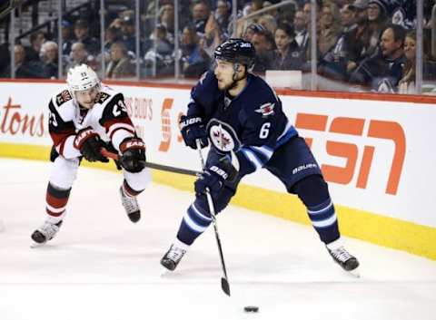 Jan 26, 2016; Winnipeg, Manitoba, CAN; Winnipeg Jets center Alexander Burmistrov (6) controls the puck on Arizona Coyotes defenseman Oliver Ekman-Larsson (23) during the third period at MTS Centre. Winnipeg wins 5-2. Mandatory Credit: Bruce Fedyck-USA TODAY Sports