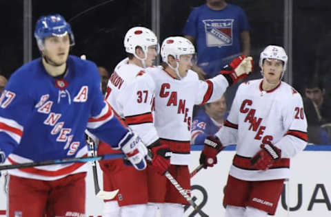 NEW YORK, NEW YORK – NOVEMBER 27: Ryan Dzingel #18 of the Carolina Hurricanes (C) celebrates his second period goal against the New York Rangers and is joined by Andrei Svechnikov #37 (L) and Sebastian Aho #20 (R) at Madison Square Garden on November 27, 2019 in New York City. (Photo by Bruce Bennett/Getty Images)