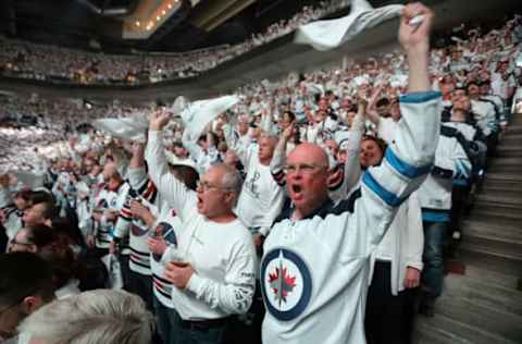 WINNIPEG, MANITOBA – APRIL 13: Fans of the Winnipeg Jets cheer their team against the Minnesota Wild in Game Two of the Western Conference First Round during the 2018 NHL Stanley Cup Playoffs on April 13, 2018 at Bell MTS Place in Winnipeg, Manitoba, Canada. (Photo by Jason Halstead /Getty Images) *** Local Caption ***