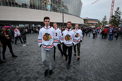 BERLIN, GERMANY – SEPTEMBER 29: Kirby Dach #77, Connor Murphy #5, Calvin de Haan #44 and Collin Delia #60 of the Chicago Blackhawks arrive to the Global Fan Tour at Mercedes Platz, prior to the NHL Global Series Challenge 2019 match between Eisbaren Berlin and Chicago Blackhawks on September 29, 2019 in Berlin, Germany. (Photo by Chase Agnello-Dean/NHLI via Getty Images)