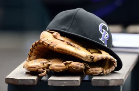 May 10, 2015; Denver, CO, USA; General view of a Colorado Rockies glove and hat during the seventh inning of the game against the Los Angeles Dodgers at Coors Field. The Dodgers defeated the Rockies 9-5. Mandatory Credit: Ron Chenoy-USA TODAY Sports