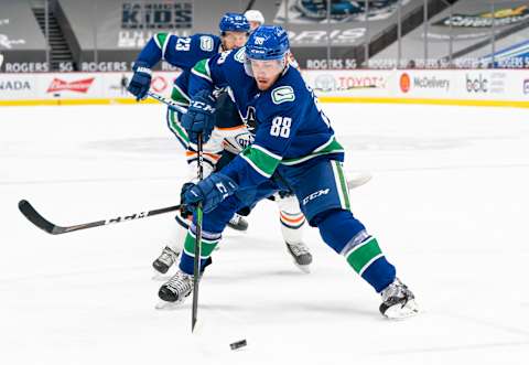 VANCOUVER, BC – MARCH 13: Nate Schmidt #88 of the Vancouver Canucks skates with the puck during NHL action against the Edmonton Oilers at Rogers Arena on March 13, 2021 in Vancouver, Canada. (Photo by Rich Lam/Getty Images)