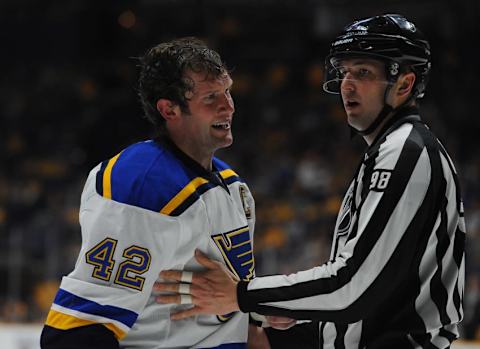 Feb 27, 2016; Nashville, TN, USA; St. Louis Blues center David Backes (42) is taken to the penalty box after a roughingcall during the second period against the Nashville Predators at Bridgestone Arena. Mandatory Credit: Christopher Hanewinckel-USA TODAY Sports