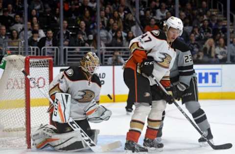 February 25, 2017; Los Angeles, CA, USA; Anaheim Ducks goalie Jonathan Bernier (1) blocks a shot as defenseman Hampus Lindholm (47) defends against Los Angeles Kings right wing Dustin Brown (23) during the second period at Staples Center. Mandatory Credit: Gary A. Vasquez-USA TODAY Sports