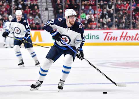 MONTREAL, QC – APRIL 11: Pierre-Luc Dubois #80 of the Winnipeg Jets skates the puck against the Montreal Canadiens during the first period at Centre Bell on April 11, 2022 in Montreal, Canada. The Winnipeg Jets defeated the Montreal Canadiens 4-2. (Photo by Minas Panagiotakis/Getty Images)