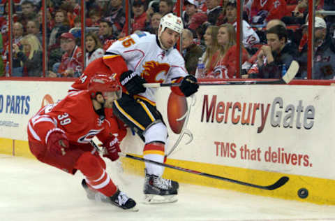 RALEIGH, NC – JANUARY 13: Shane O’Brien #55 of the Calgary Flames clears the puck against Patrick Dwyer #39 of the Carolina Hurricanes at PNC Arena on January 13, 2014, in Raleigh, North Carolina. The Flames defeated the Hurricanes 2-0. (Photo by Lance King/Getty Images)