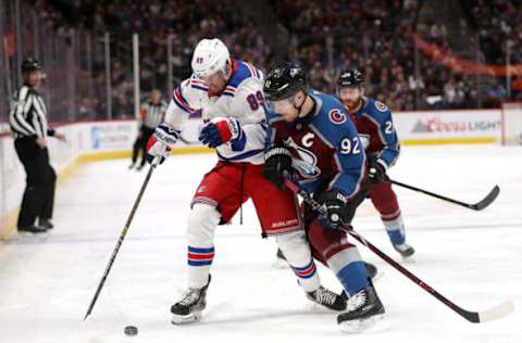 DENVER, COLORADO – JANUARY 04: Pavel Buchnevich #89 of the New York Rangers fights for the puck against Gabriel Landeskog #92 of the Colorado Avalanche in the first period at the Pepsi Center on January 04, 2019 in Denver, Colorado. (Photo by Matthew Stockman/Getty Images)