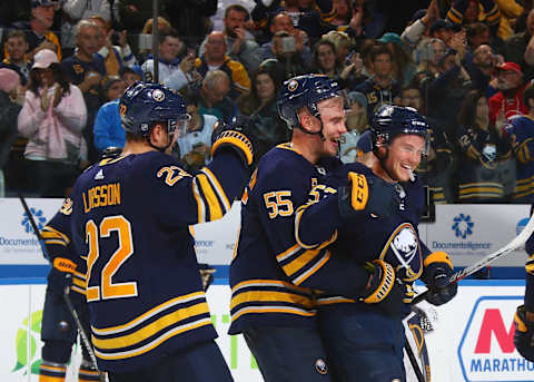 BUFFALO, NY – OCTOBER 22: Johan Larsson #22, Rasmus Ristolainen #55 and Jeff Skinner #53 of the Buffalo Sabres celebrates their overtime win against the San Jose Sharks during an NHL game on October 22, 2019 at KeyBank Center in Buffalo, New York. Buffalo won, 4-3. (Photo by Rob Marczynski/NHLI via Getty Images)