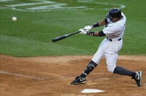 Oct 2, 2011; Bronx, NY, USA; New York Yankees center fielder Curtis Granderson (14) homers during the eighth inning of game two of the 2011 ALDS against the Detroit Tigers at Yankee Stadium. Mandatory Credit: Anthony Gruppuso-US PRESSWIRE