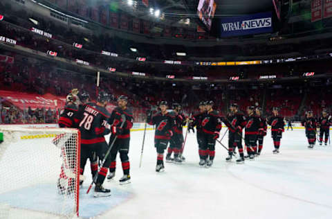 Mar 11, 2021; Raleigh, North Carolina, USA; Carolina Hurricanes players celebrate after defeating the Nashville Predators at PNC Arena. Mandatory Credit: James Guillory-USA TODAY Sports