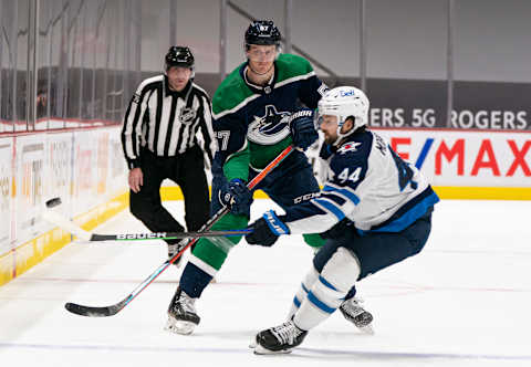 Tyler Myers #57, Vancouver Canucks; Josh Morrissey #44, Winnipeg Jets. (Photo by Rich Lam/Getty Images)