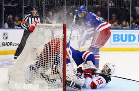 NEW YORK, NEW YORK – APRIL 24: Nico Hischier #13 of the New Jersey Devils slides into Igor Shesterkin #31 of the New York Rangers during the third period in Game Four of the First Round of the 2023 Stanley Cup Playoffs at Madison Square Garden on April 24, 2023, in New York, New York. The Devils defeated the Rangers 3-1. (Photo by Bruce Bennett/Getty Images)