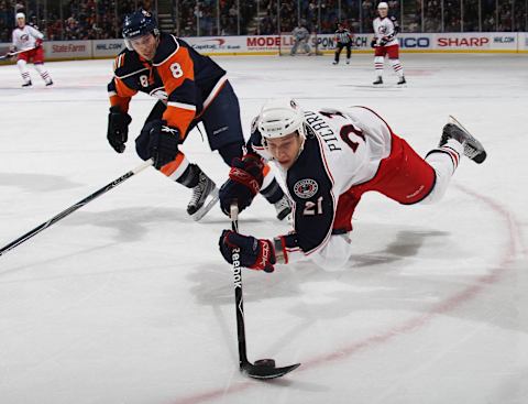 UNIONDALE, NY – DECEMBER 29: Alexandre Picard #21 of the Columbus Blue Jackets trips with the puck as he carries against Bruno Gervais #8 of the New York Islanders at the Nassau Coliseum on December 29, 2009 in Uniondale, New York. (Photo by Bruce Bennett/Getty Images)