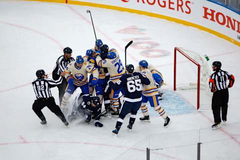 HAMILTON, ONTARIO – MARCH 13: Toronto Maple Leafs and Buffalo Sabres fight during the Heritage Classic at Tim Hortons Field on March 13, 2022 in Hamilton, Ontario. (Photo by Vaughn Ridley/Getty Images)