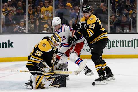 Apr 23, 2022; Boston, Massachusetts, USA; Boston Bruins goaltender Linus Ullmark (35) makes a save as defenseman Hampus Lindholm (27) clears New York Rangers left wing Dryden Hunt (29) away from the rebound during the first period at TD Garden. Mandatory Credit: Winslow Townson-USA TODAY Sports