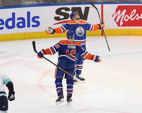 EDMONTON, CANADA – NOVEMBER 15: Evander Kane #91 and Zach Hyman #18 of the Edmonton Oilers celebrate his hat-trick goal in overtime against the Seattle Kraken at Rogers Place on November 15, 2023 in Edmonton, Alberta, Canada. (Photo by Lawrence Scott/Getty Images)