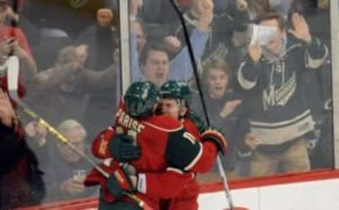 Mar 1, 2016; Saint Paul, MN, USA; Minnesota Wild forward Zach Parise (11) celebrates with center Charlie Coyle (3) on the Parise to Coyle pass leading to a goal breaking the tie score during the third period against the Colorado Avalanche at Xcel Energy Center. The Wild win 6-3 over the Avalanche. Mandatory Credit: Marilyn Indahl-USA TODAY Sports