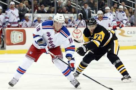 Mar 3, 2016; Pittsburgh, PA, USA; New York Rangers center J.T. Miller (10) carries the puck against pressure from Pittsburgh Penguins center Evgeni Malkin (71) during the first period at the CONSOL Energy Center. Mandatory Credit: Charles LeClaire-USA TODAY Sports