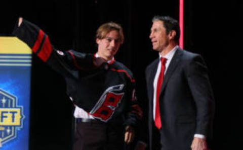 NASHVILLE, TENNESSEE – JUNE 28: Head coach Rod Brind’Amour of the Carolina Hurricanes presents Bradly Nadeau with a jersey after being selected with the 30th overall pick during round one of the 2023 Upper Deck NHL Draft at Bridgestone Arena on June 28, 2023 in Nashville, Tennessee. (Photo by Bruce Bennett/Getty Images)