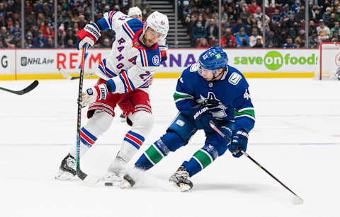 VANCOUVER, BC – NOVEMBER 2: Barclay Goodrow #21 of the New York Rangers tries to get around Quinn Hughes #43 of the Vancouver Canucks during the first period on November, 2, 2021 at Rogers Arena in Vancouver, British Columbia, Canada. (Photo by Rich Lam/Getty Images)