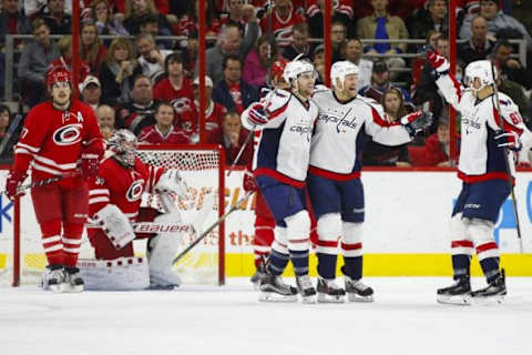 Dec 21, 2015; Raleigh, NC, USA; Washington Capitals forward Jason Chimera (25) celebrates with forward Tom Wilson (43) and forward Jay Beagle (83) after scoring a goal in the second period against the Carolina Hurricanes at PNC Arena. Mandatory Credit: James Guillory-USA TODAY Sports