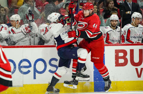 RALEIGH, NC – SEPTEMBER 29: Carolina Hurricanes right wing Julien Gauthier (44) checks Washington Capitals defenseman Martin Fehervary (42) in front of his bench during an NHL Preseason game between the Washington Capitals and the Carolina Hurricanes on September 29, 2019 at the PNC Arena in Raleigh, NC. (Photo by Greg Thompson/Icon Sportswire via Getty Images)