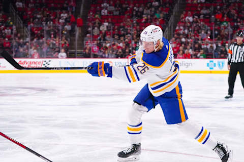 Dec 4, 2021; Raleigh, North Carolina, USA; Buffalo Sabres defenseman Rasmus Dahlin (26) takes a first period shot against the Carolina Hurricanes at PNC Arena. Mandatory Credit: James Guillory-USA TODAY Sports