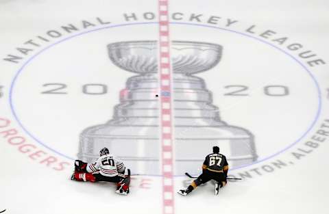 Corey Crawford #50 of the Chicago Blackhawks stretches along with Max Pacioretty #67 of the Vegas Golden Knights before the start of Game One of the Western Conference First Round during the 2020 NHL Stanley Cup Playoffs. (Photo by Jeff Vinnick/Getty Images)