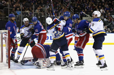 NEW YORK, NEW YORK – DECEMBER 05: Vitali Kravtsov #74 of the New York Rangers holds back Nathan Walker #26 of the St. Louis Blues during the first period at Madison Square Garden on December 05, 2022, in New York City. (Photo by Bruce Bennett/Getty Images)