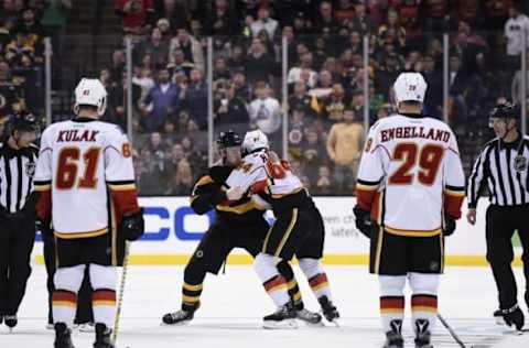 Nov 25, 2016; Boston, MA, USA; Calgary Flames defenseman Brett Kulak (61) and defenseman Deryk Engelland (29) watch a fight between right wing Garnet Hathaway (64) and Boston Bruins right wing Jimmy Hayes (11) during the third period at TD Garden. Mandatory Credit: Bob DeChiara-USA TODAY Sports