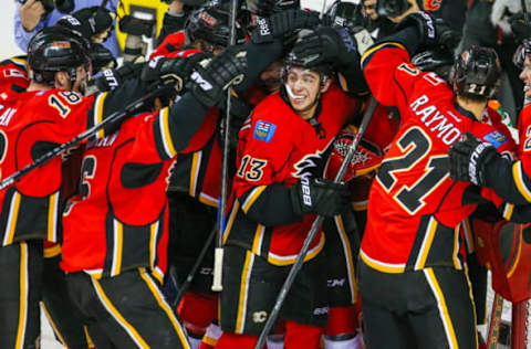 Apr 9, 2015; Calgary, Alberta, CAN; Calgary Flames left wing Johnny Gaudreau (13) celebrate with teammates Calgary Flames win over Los Angeles Kings at Scotiabank Saddledome. Calgary Flames won 3-1. Mandatory Credit: Sergei Belski-USA TODAY Sports