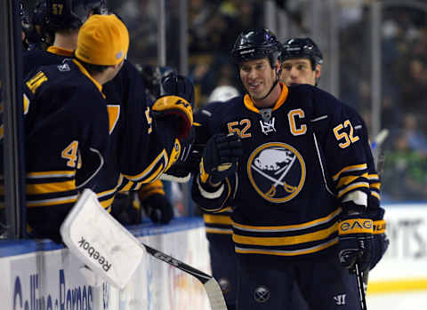 Dec 21, 2010; Buffalo, NY, USA; Buffalo Sabres defenseman Craig Rivet (52) celebrates a third period goal with teammates during a game against the Anaheim Ducks at HSBC Arena. Buffalo defeats Anaheim 5-2. Mandatory Credit: Timothy T. Ludwig-USA TODAY Sports