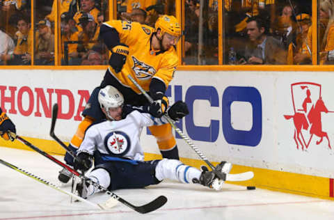 NASHVILLE, TN – MAY 10: Alexei Emelin #25 of the Nashville Predators stands over Brandon Tanev #13 of the Winnipeg Jets during the second period in Game Seven of the Western Conference Second Round during the 2018 NHL Stanley Cup Playoffs at Bridgestone Arena on May 10, 2018 in Nashville, Tennessee. (Photo by Frederick Breedon/Getty Images)