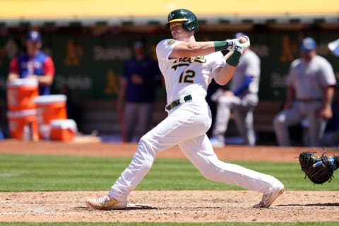 May 29, 2022; Oakland, California, USA; Oakland Athletics catcher Sean Murphy (12) hits an RBI double against the Texas Rangers during the fifth inning at RingCentral Coliseum. Mandatory Credit: Darren Yamashita-USA TODAY Sports