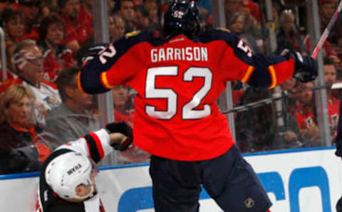 SUNRISE, FL – APRIL 13: Stephen Gionta #11 of the New Jersey Devils is checked into the boards by Jason Garrison #52 of the Florida Panthers in Game One of the Eastern Conference Quarterfinals during the 2012 NHL Stanley Cup Playoffs at the BankAtlantic Center on April 13, 2012 in Sunrise, Florida. (Photo by Joel Auerbach/Getty Images)