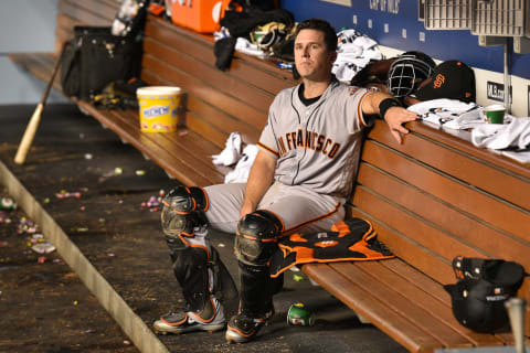 LOS ANGELES, CA – AUGUST 15: San Francisco Giants catcher Buster Posey (28) looks on from the dugout during a MLB game between the San Francisco Giants and the Los Angeles Dodgers on August 15, 2018 at Dodger Stadium in Los Angeles, CA. (Photo by Brian Rothmuller/Icon Sportswire via Getty Images)