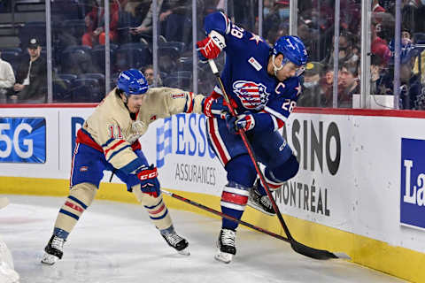 LAVAL, QC – APRIL 08: Michael Mersch #28 of the Rochester Americans and Rafael Harvey-Pinard #11 of the Laval Rocket battle along the boards during the first period at Place Bell on April 8, 2022 in Laval, Canada. (Photo by Minas Panagiotakis/Getty Images)