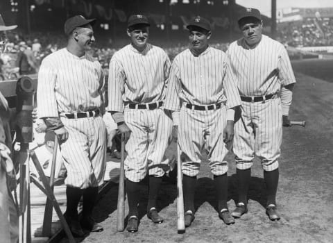 (Original Caption) Left to right; Lou Gehrig, 1st base; Earl Combs, center field; Tony Lazzer, 3rd base; and the one and only Babe Ruth, right field; in front of their dugout before their first game of the 1931 season against the Boston Red Sox at the Yankee Stadium here. (Photo by George Rinhart/Corbis via Getty Images)